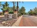 Landscaped entrance to the community with brick pavement and signage at 9711 E Mountain View Rd # 1516, Scottsdale, AZ 85258