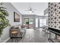 Spacious living room with gray sofa, tile floor, and fireplace at 9711 E Mountain View Rd # 1516, Scottsdale, AZ 85258