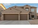 Two-story house with three car garage and desert landscaping at 11867 W Grant St, Avondale, AZ 85323