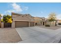 Two-story house with three car garage and desert landscaping at 11867 W Grant St, Avondale, AZ 85323