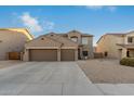 Two-story house with three car garage and desert landscaping at 11867 W Grant St, Avondale, AZ 85323