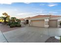 Tan two-car garage and front yard with drought-tolerant landscaping at 13555 W Via Tercero --, Sun City West, AZ 85375