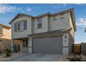 Two-story home with gray exterior, two-car garage, and landscaping at 16979 W Butler Ave, Waddell, AZ 85355