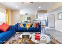 Bright living room with comfy blue sofa and view into kitchen at 17621 N 18Th Dr, Phoenix, AZ 85023