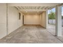 Covered carport with concrete flooring and overhead lighting at 2015 W Chambers St, Phoenix, AZ 85041