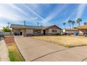 Ranch-style home with a spacious yard and a long driveway at 2923 W Wethersfield Rd, Phoenix, AZ 85029