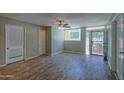 Bright living room featuring wood-look tile floors and access to patio at 6115 N 12Th St # 1, Phoenix, AZ 85014