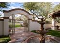 Ornate iron gate entry to a private courtyard with a fountain at 8145 N 68Th St, Paradise Valley, AZ 85253