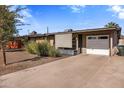 Ranch style home with attached garage and desert landscaping at 1008 W Amelia Ave, Phoenix, AZ 85013
