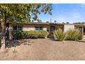 Mid-century modern home with a neatly landscaped front yard at 1008 W Amelia Ave, Phoenix, AZ 85013