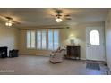 Bright living room featuring tile floors and plantation shutters at 10185 W Pasadena Dr, Casa Grande, AZ 85194