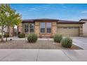 Single-story home with stone accents and a two-car garage at 17957 W Fairview St, Goodyear, AZ 85338