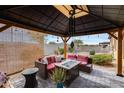 Covered patio with seating area and fire pit at 17957 W Fairview St, Goodyear, AZ 85338