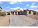 Single story house with a two-car garage and desert landscaping at 5426 W Ian Dr, Laveen, AZ 85339