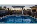 Relaxing pool with a waterfall feature and lush landscaping at 5750 S 101St Way, Mesa, AZ 85212