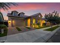 Inviting home exterior with a stone facade and well-manicured lawn at 10565 E Monterey Ave, Mesa, AZ 85209