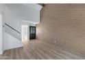 Living room features wood accent wall and wood-look floors at 2435 W Greenway Rd # 2, Phoenix, AZ 85023