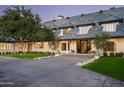 Impressive home entrance with stone driveway and landscaping at 34 Biltmore Est, Phoenix, AZ 85016