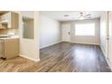 Living room with hardwood floors, neutral walls, and access to the kitchen at 6219 S 12Th Pl, Phoenix, AZ 85042