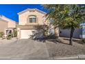 Two-story home with attached garage, desert landscaping, and a paved driveway at 6538 E Quiet Retreat --, Florence, AZ 85132