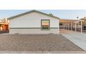 View of the home's side, showing carport and landscaping at 825 W Calle Del Norte --, Chandler, AZ 85225