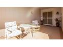 Small patio with table and chairs, adjacent to the entrance at 12822 W Prospect Dr, Sun City West, AZ 85375