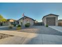 House exterior with a three-car garage and American flag at 21999 E Camacho Rd, Queen Creek, AZ 85142