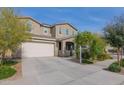 Two-story house with attached garage and landscaped front yard at 23046 E Estrella Rd, Queen Creek, AZ 85142