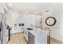 Modern kitchen with white cabinets, quartz countertops, and stainless steel appliances at 3131 N Central Ave # 6017, Phoenix, AZ 85012