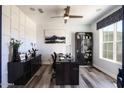 Home office with built-in shelving and hardwood floors at 4414 W Jacaranda Dr, Eloy, AZ 85131