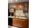 Updated kitchen with wood cabinetry and stainless steel sink at 6125 E Indian School Rd # 164, Scottsdale, AZ 85251