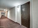 Condo hallway with wood door to unit at 7920 E Camelback Rd # 609, Scottsdale, AZ 85251