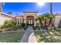 Elegant entryway with double doors, brick walkway, and landscaping at 9840 N 111Th Pl, Scottsdale, AZ 85259