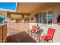 Covered patio with seating and brick wall at 10412 W Audrey Dr, Sun City, AZ 85351