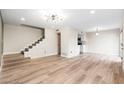 Open living area with wood-look floors and a view of the kitchen at 1136 N 84Th Pl, Scottsdale, AZ 85257