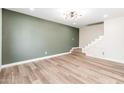 Spacious living room with wood-look floors and a staircase at 1136 N 84Th Pl, Scottsdale, AZ 85257