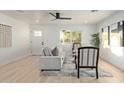 Living room with modern furnishings, wood-look flooring, and abundant natural light at 120 E Linda Ln, Gilbert, AZ 85234