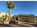 A palm tree stands tall in front of this single-story home with carport at 16041 N 31St St # 16, Phoenix, AZ 85032
