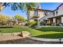 Spacious backyard with artificial turf and a stone patio at 10191 E Diamond Rim Dr # 2122, Scottsdale, AZ 85255