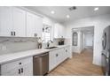 Modern kitchen with white shaker cabinets, stainless steel appliances and quartz countertops at 1731 E Verde Ln, Phoenix, AZ 85016