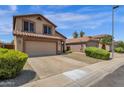 Two-story house with tan exterior, two-car garage, and landscaped front yard at 18110 N Skyhawk Dr, Surprise, AZ 85374