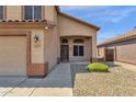 Front entry of two-story house with door, walkway and landscaping at 18110 N Skyhawk Dr, Surprise, AZ 85374