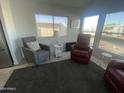 Living room with gray and red armchairs, rug, and window views at 2205 W Klamath Ave, Apache Junction, AZ 85119