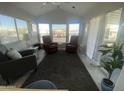 Bright living room with two red leather recliners and large windows at 2205 W Klamath Ave, Apache Junction, AZ 85119