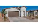 Modern home with a two-car garage and neatly landscaped front yard at 22862 E Bonanza Way, Queen Creek, AZ 85142