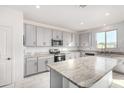 Modern kitchen with gray cabinets and granite island at 2439 W Kowalsky Ln, Phoenix, AZ 85041