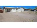 Front view of a house with a large driveway and landscaping at 3338 W Palmaire Ave, Phoenix, AZ 85051