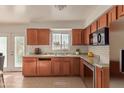 Kitchen with wood cabinets, tile backsplash, and stainless steel appliances at 3605 W Bethany Home Rd # 21, Phoenix, AZ 85019
