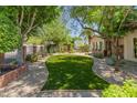 Landscaped front yard with artificial turf and a brick pathway at 5524 N 3Rd Ave, Phoenix, AZ 85013