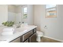 Clean bathroom with dark brown vanity and white countertop at 8828 S 167Th Ln, Goodyear, AZ 85338